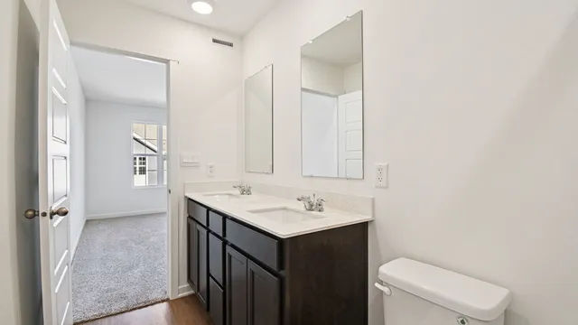 a bathroom with a sink toilet and mirror