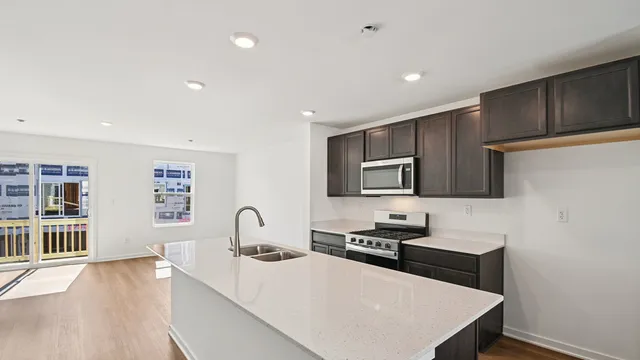 a kitchen with stainless steel appliances a stove microwave and cabinets