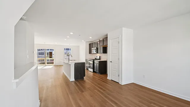 a view of a kitchen with wooden floor and electronic appliances