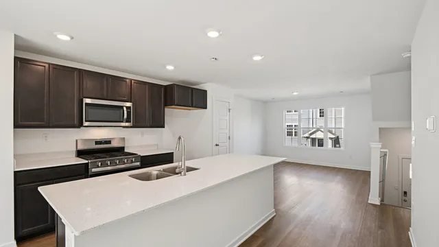 a kitchen with stainless steel appliances a refrigerator stove top oven and cabinets