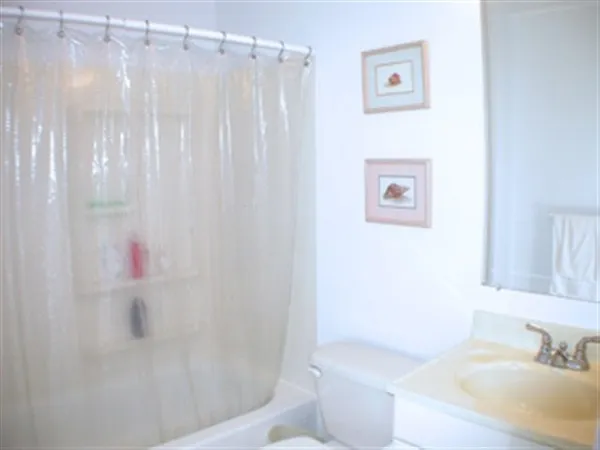 a bathroom with a shower curtain and a sink