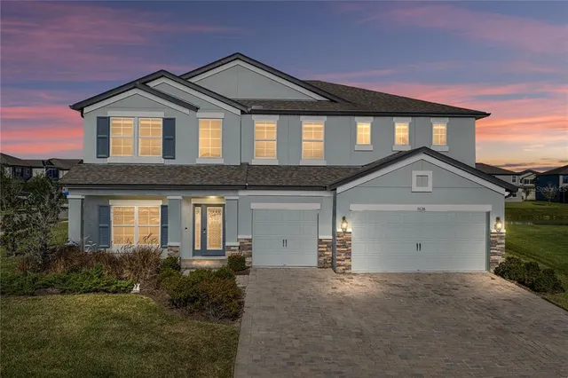 a front view of a house with a yard and garage