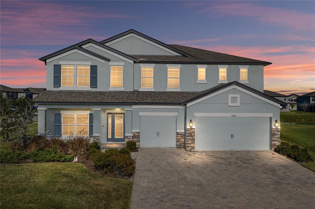 a front view of a house with a yard and garage