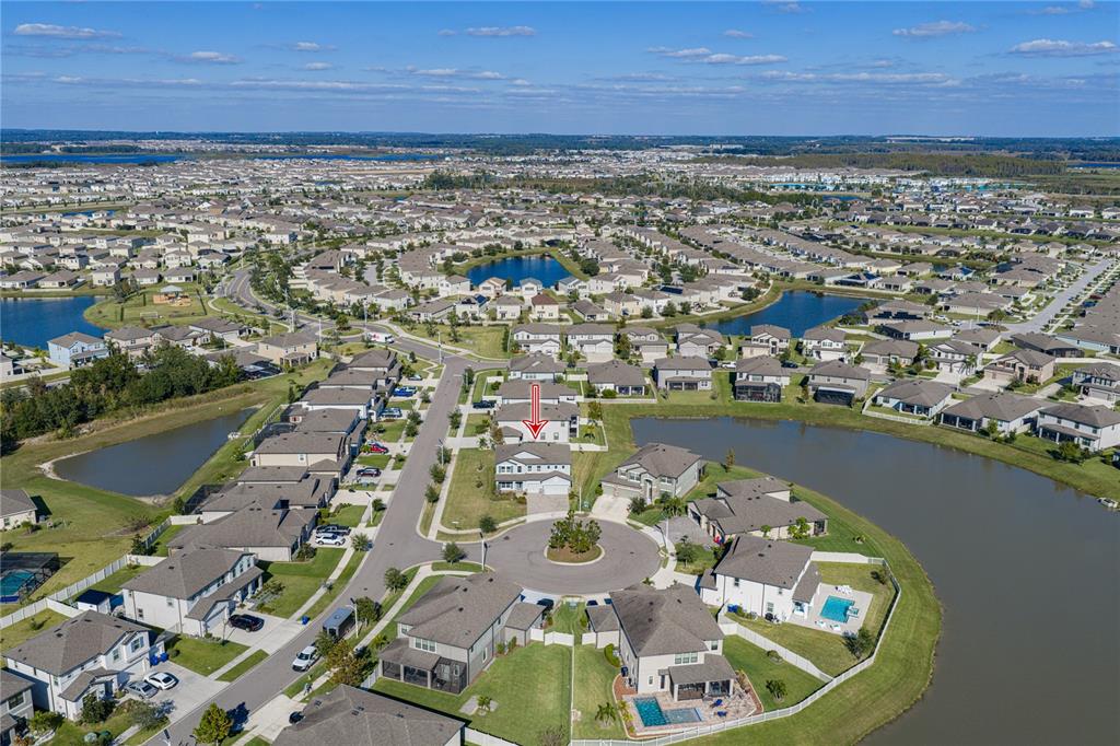 7628 Surf Reed Way Wesley Chapel, FL 33545 - Photo 2 of 76 an aerial view of a house with a lake view
