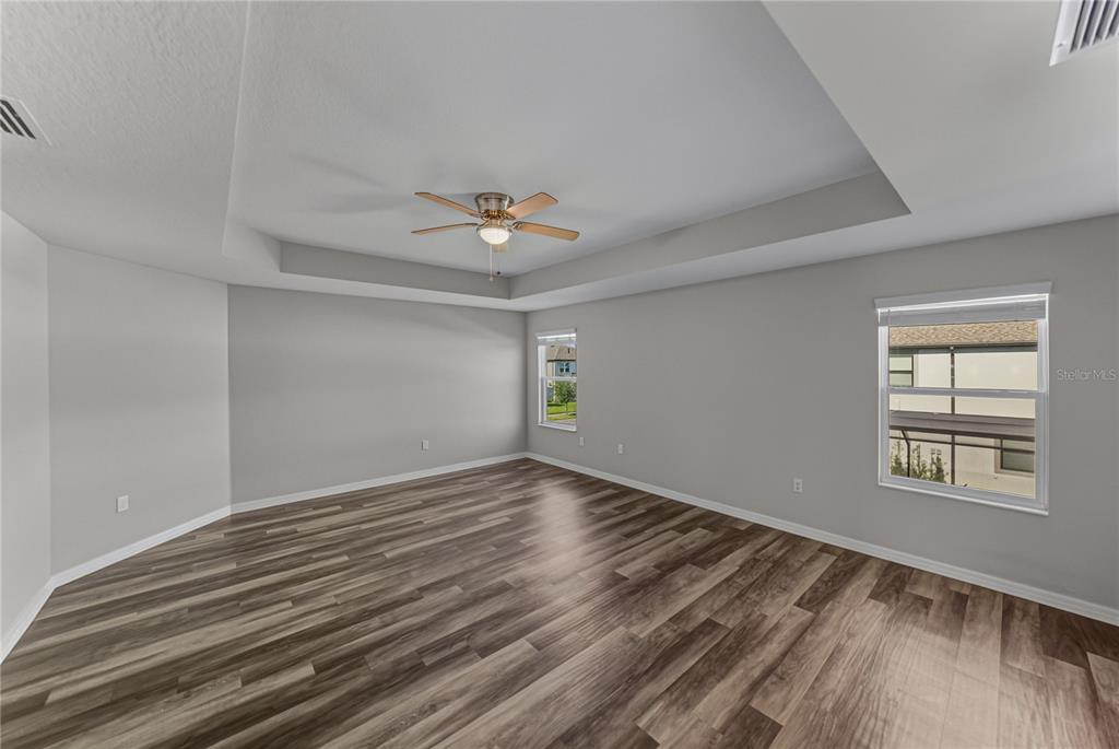 7628 Surf Reed Way Wesley Chapel, FL 33545 - Photo 31 of 76 a view of an empty room with windows