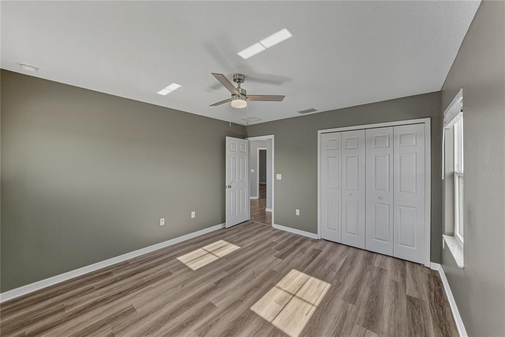 7628 Surf Reed Way Wesley Chapel, FL 33545 - Photo 41 of 76 wooden floor in an empty room with a window
