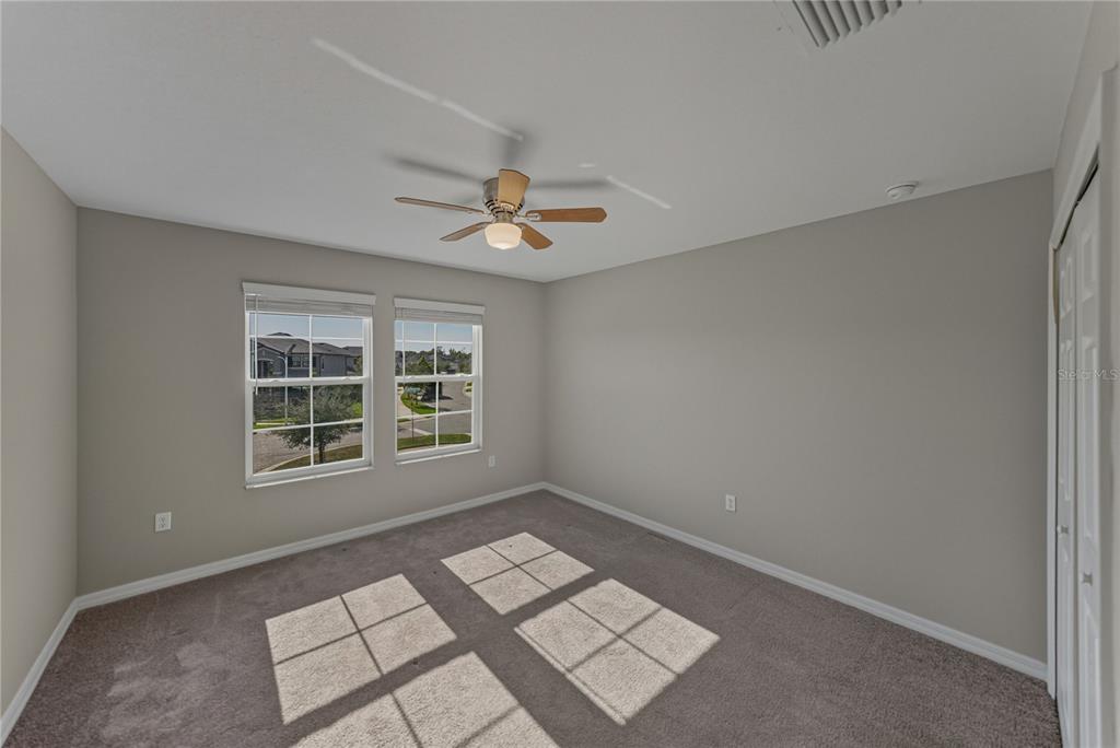 7628 Surf Reed Way Wesley Chapel, FL 33545 - Photo 42 of 76 a view of an empty room with a window
