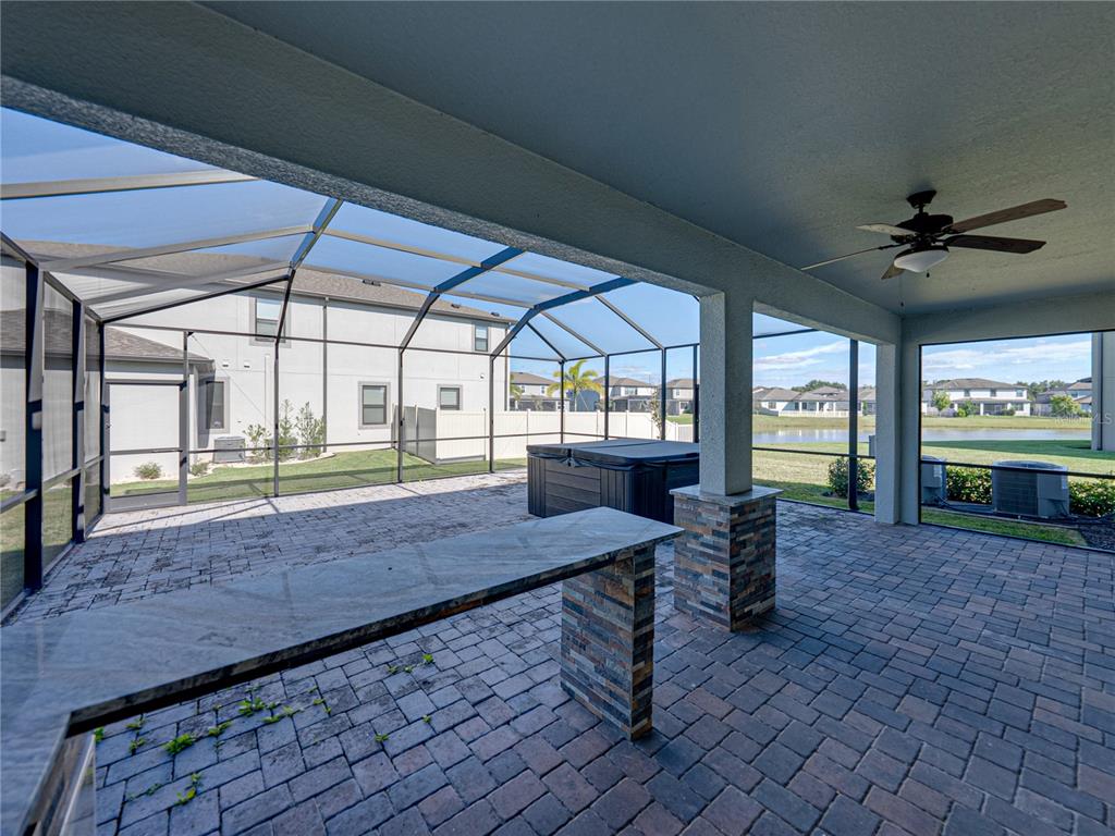 7628 Surf Reed Way Wesley Chapel, FL 33545 - Photo 52 of 76 a view of a porch with furniture and a yard