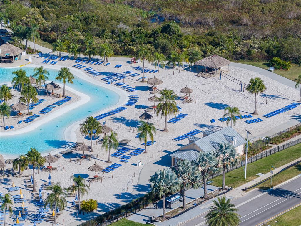 7628 Surf Reed Way Wesley Chapel, FL 33545 - Photo 68 of 76 an aerial view of a city with lots of residential buildings ocean and mountain view in back