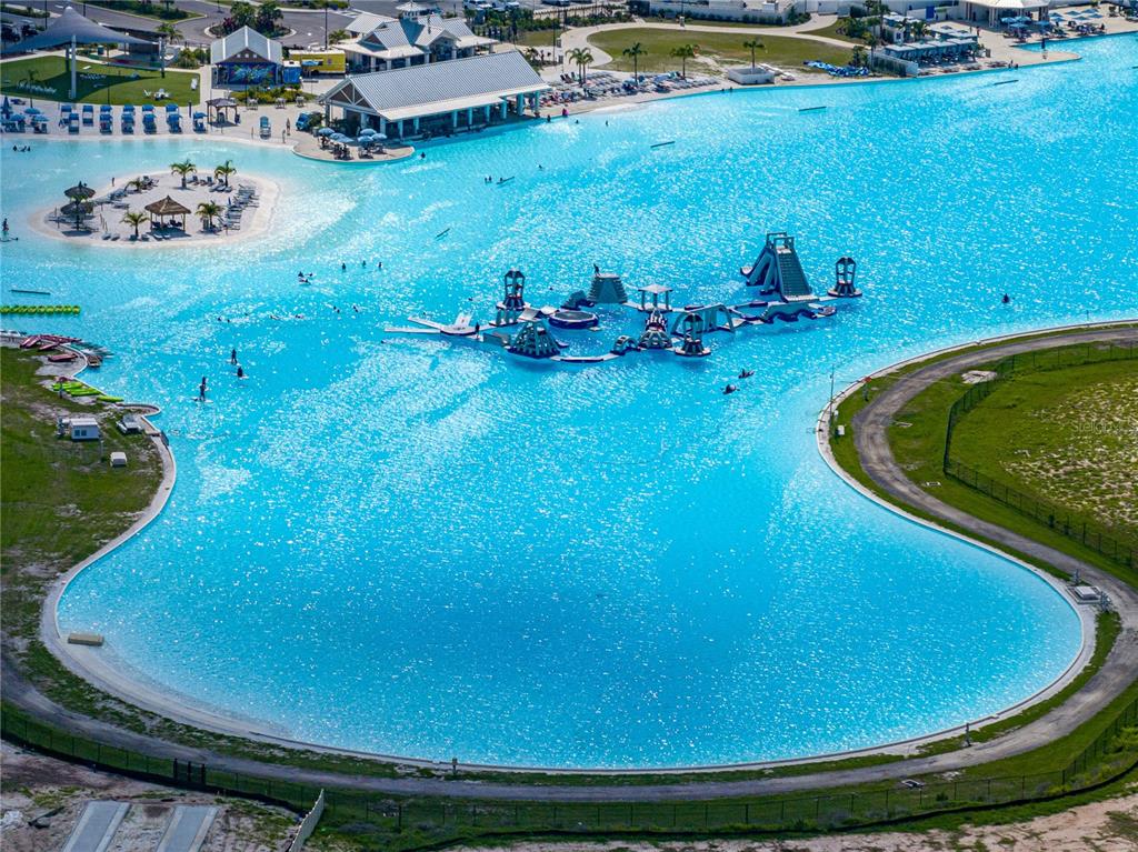 7628 Surf Reed Way Wesley Chapel, FL 33545 - Photo 74 of 76 a view of a swimming pool with lawn chairs