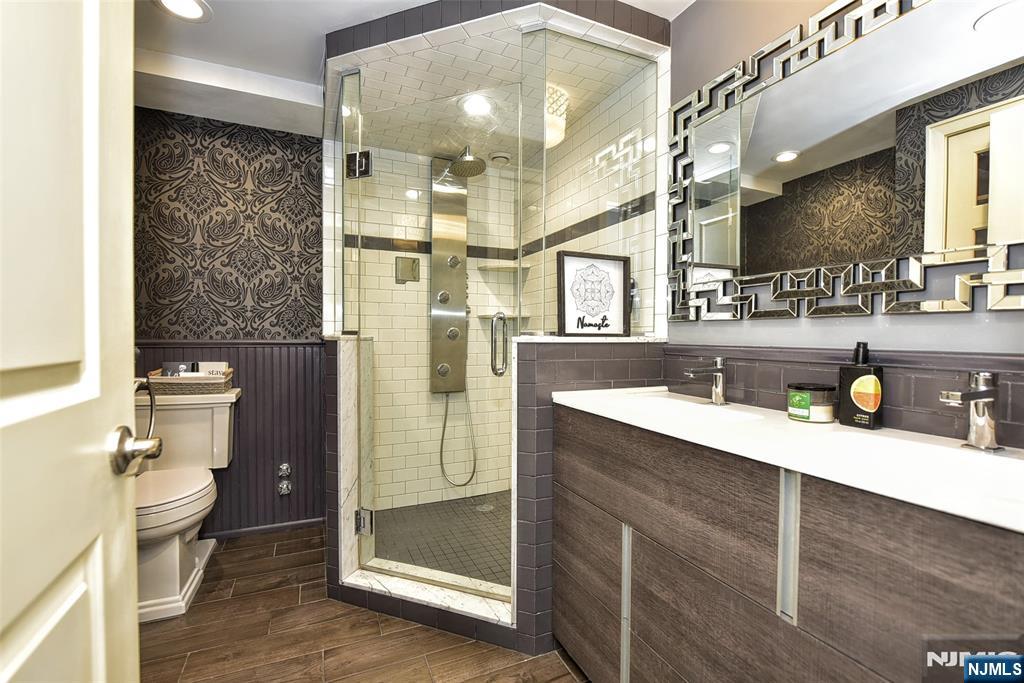 301 Beech Street, Unit 2F Hackensack, NJ 07601 - Photo 17 of 21 a bathroom with a sink mirror toilet and shower