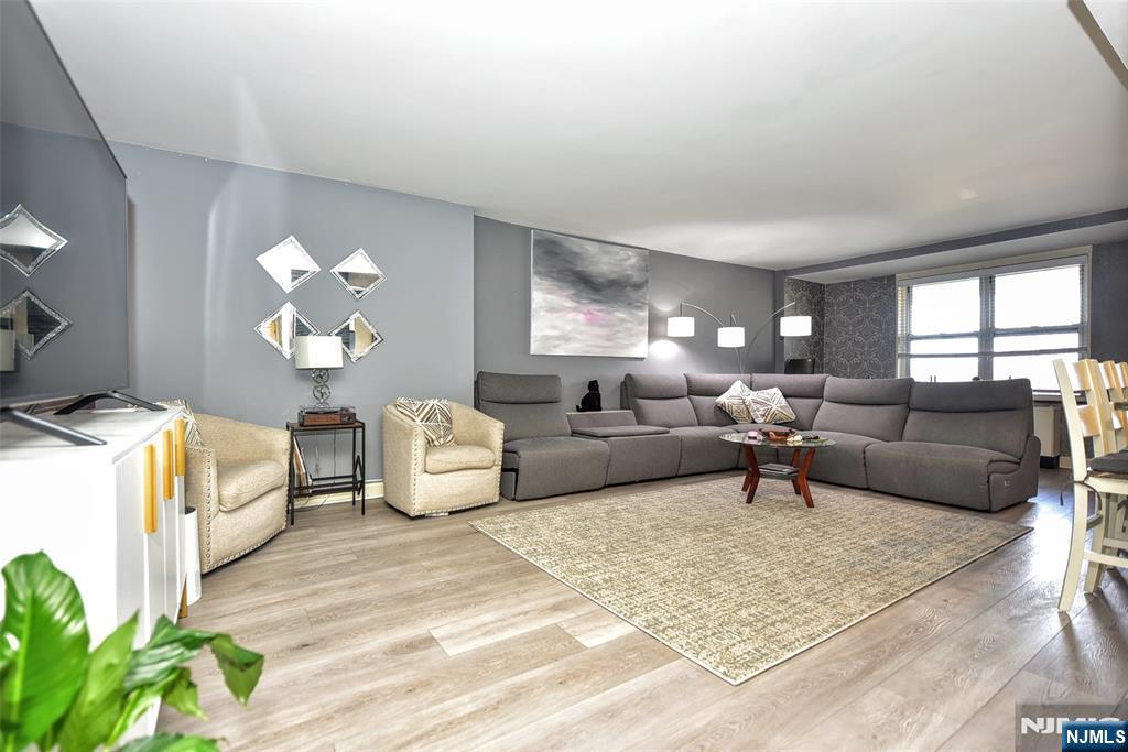 301 Beech Street, Unit 2F Hackensack, NJ 07601 - Photo 5 of 21 a living room with furniture and a chandelier