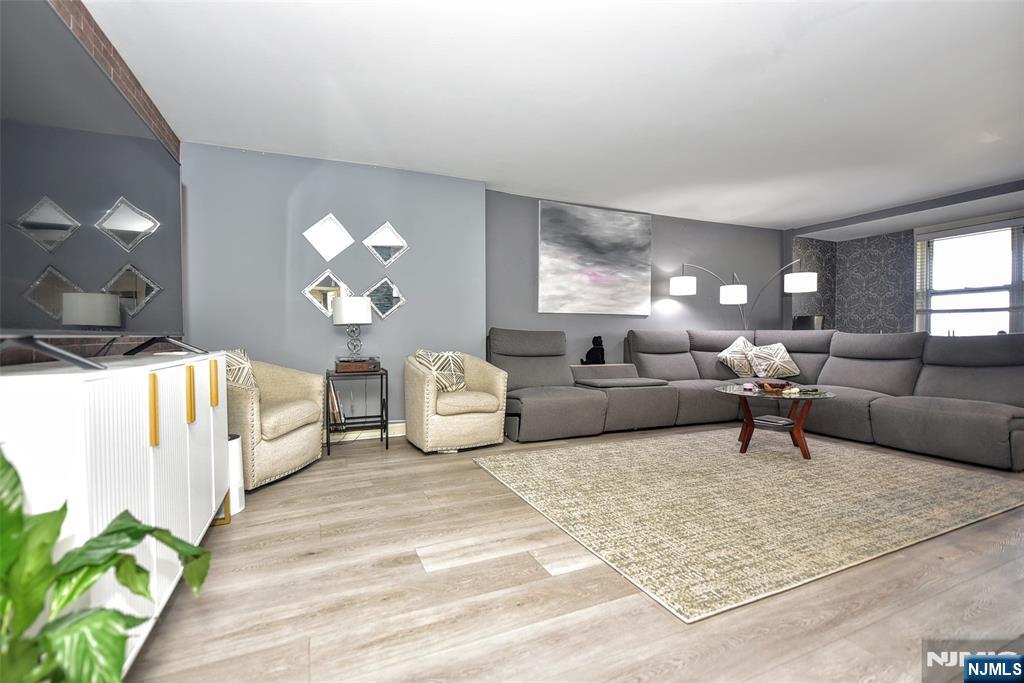 301 Beech Street, Unit 2F Hackensack, NJ 07601 - Photo 6 of 21 a living room with furniture and a chandelier