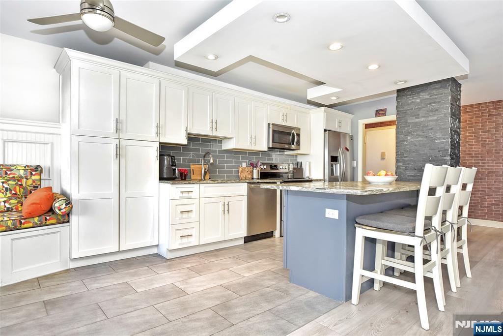 301 Beech Street, Unit 2F Hackensack, NJ 07601 - Photo 7 of 21 a kitchen with white cabinets and appliances