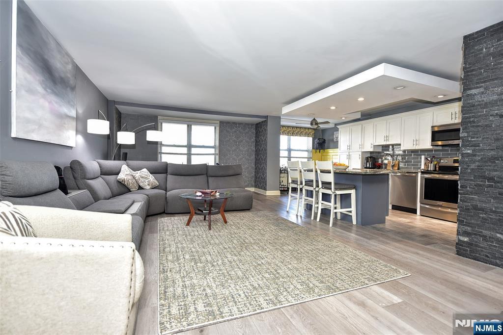 301 Beech Street, Unit 2F Hackensack, NJ 07601 - Photo 10 of 21 a living room with furniture and a kitchen appliance view