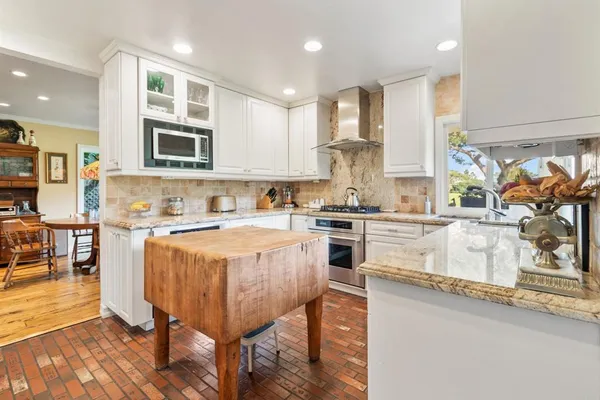 a kitchen with a stove a sink and a refrigerator
