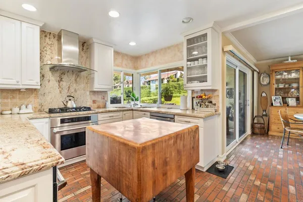 a dining room with furniture a chandelier and wooden floor