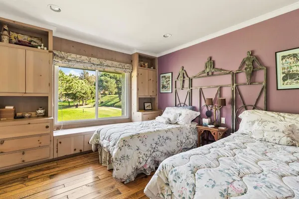 a bed sitting in a bedroom next to a window