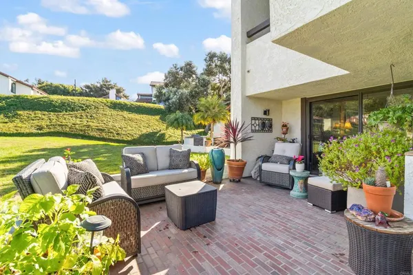 a view of a patio with couches and potted plants