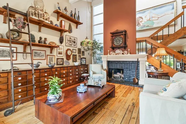 a living room with fireplace furniture and a wooden floor