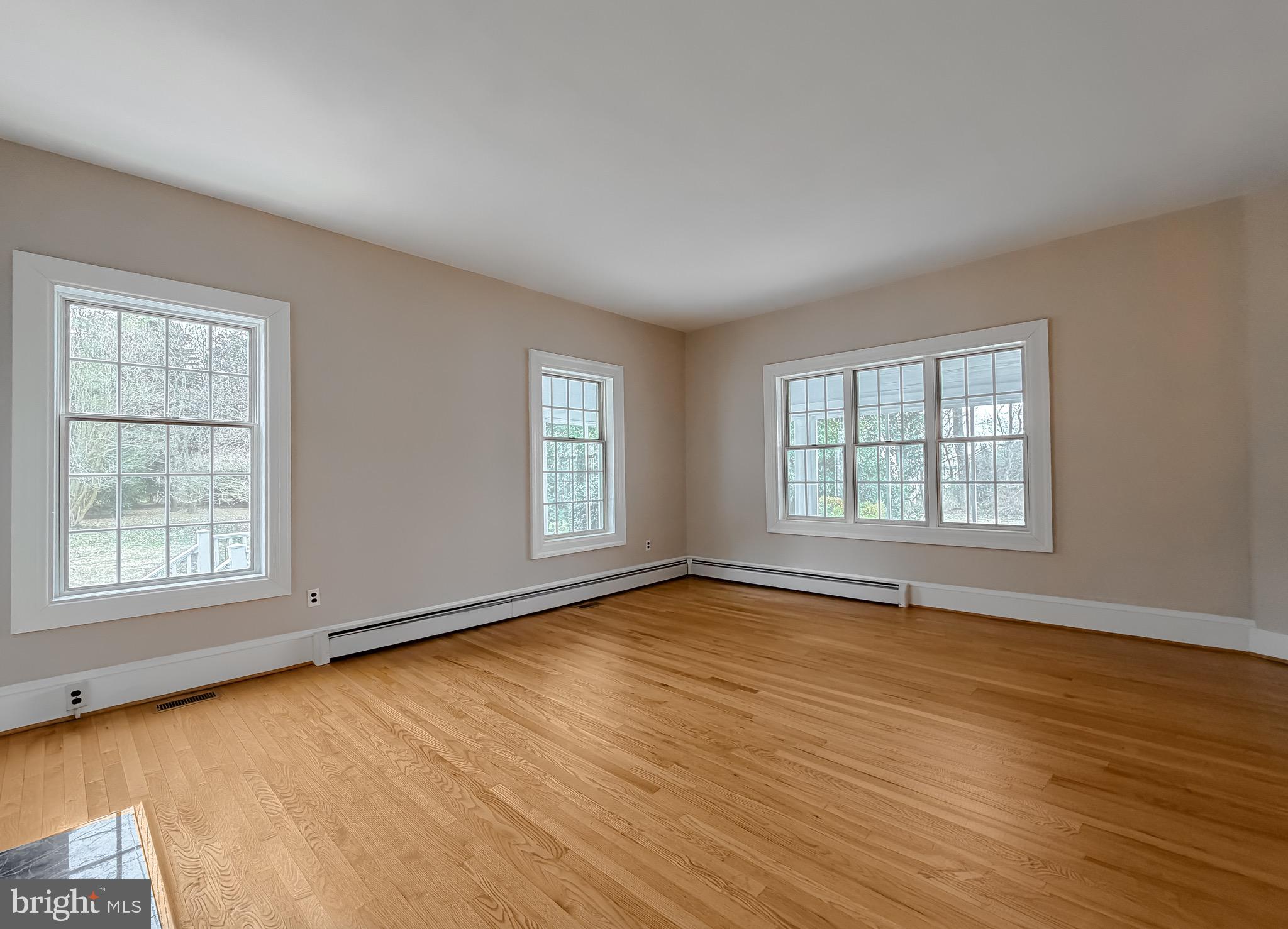 2790 Spout Lane Lusby, MD 20657 - Photo 29 of 95 an empty room with wooden floor and windows