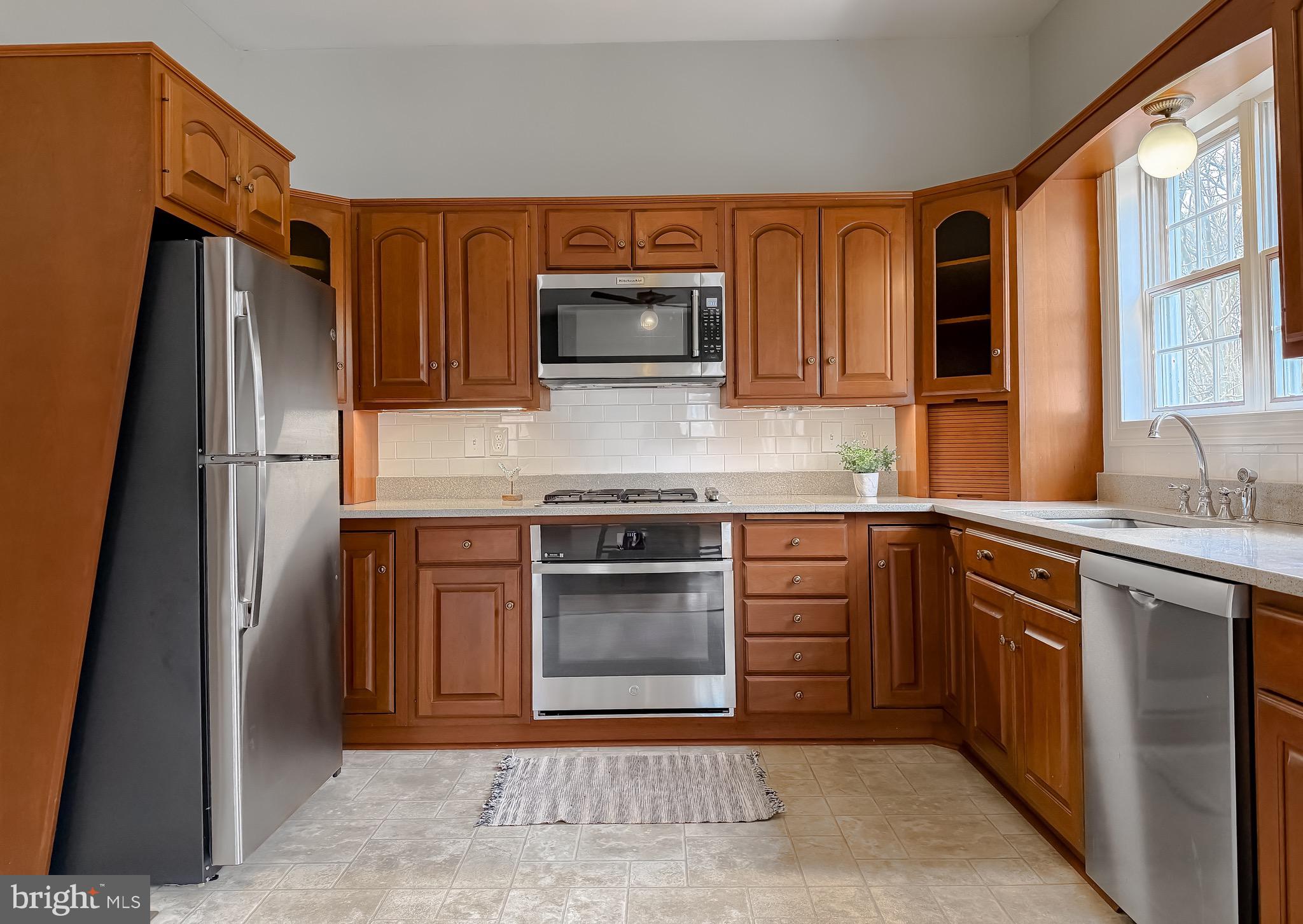 2790 Spout Lane Lusby, MD 20657 - Photo 38 of 95 a kitchen with stainless steel appliances granite countertop a refrigerator and a stove top oven