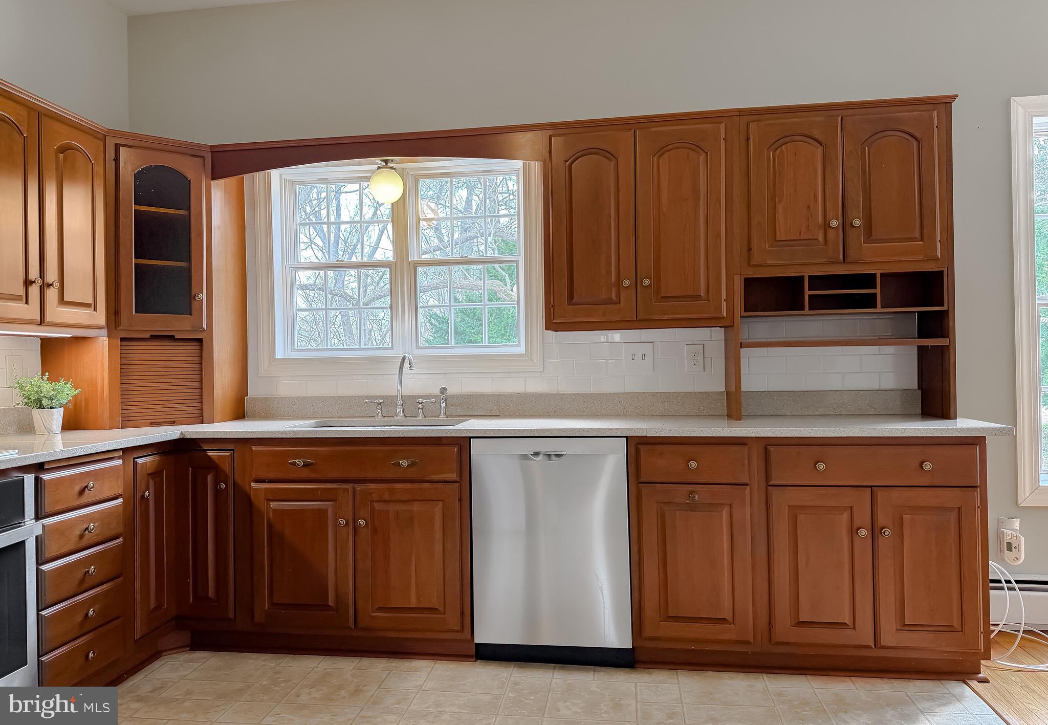 2790 Spout Lane Lusby, MD 20657 - Photo 39 of 95 a kitchen with stainless steel appliances granite countertop a sink and cabinets with wooden floor
