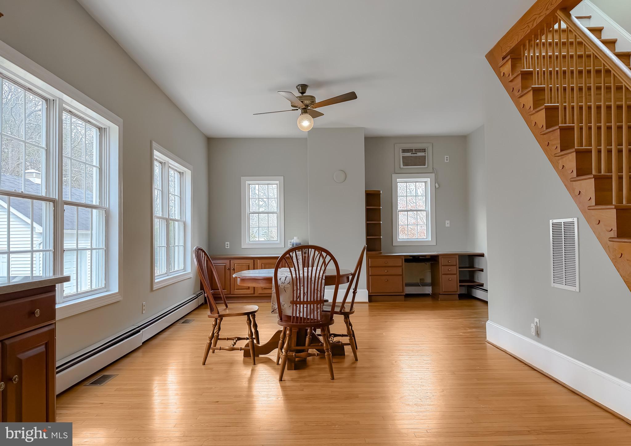 2790 Spout Lane Lusby, MD 20657 - Photo 42 of 95 a dining room with furniture window wooden floor and a chandelier