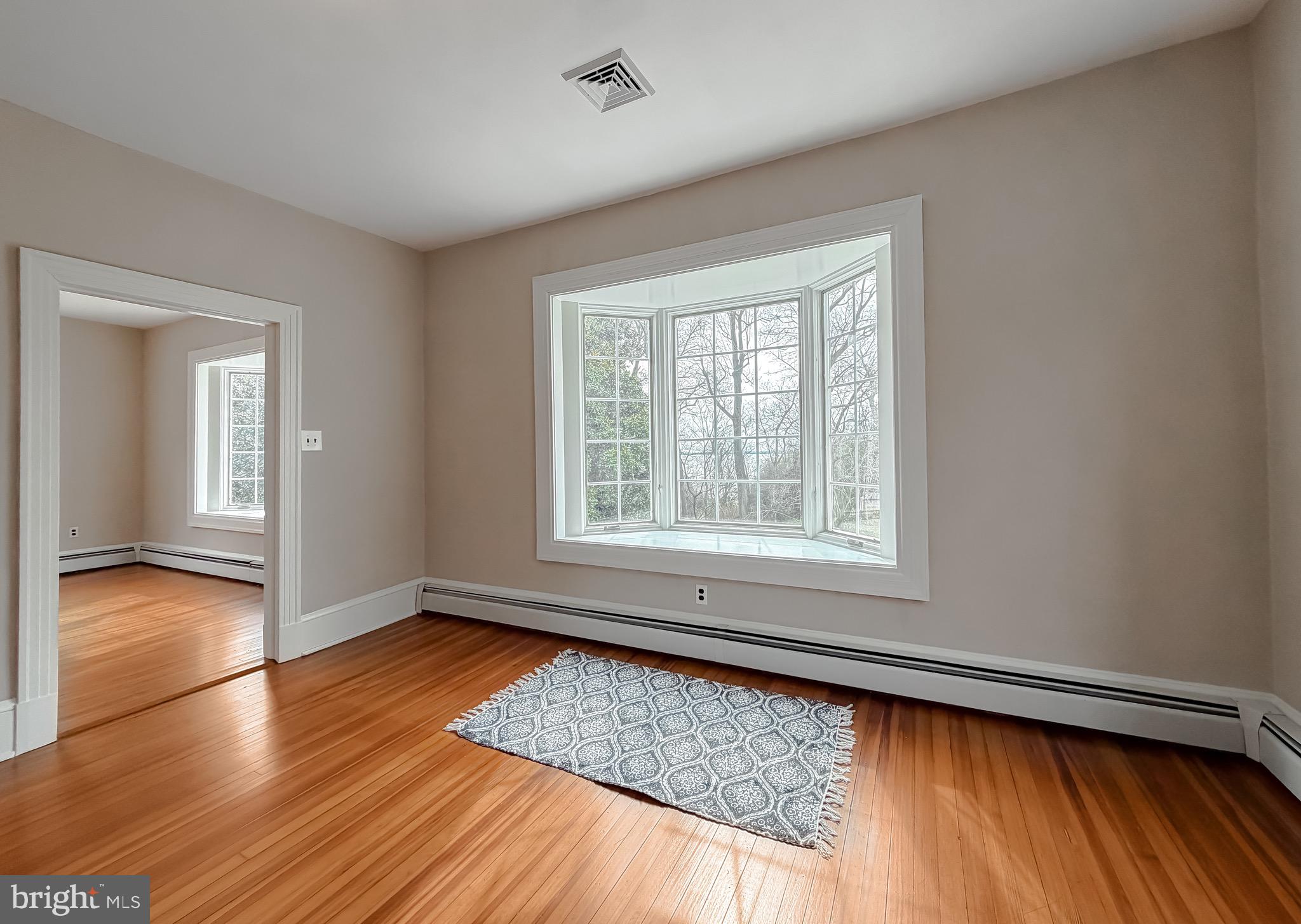 2790 Spout Lane Lusby, MD 20657 - Photo 51 of 95 a view of an empty room with wooden floor and a window