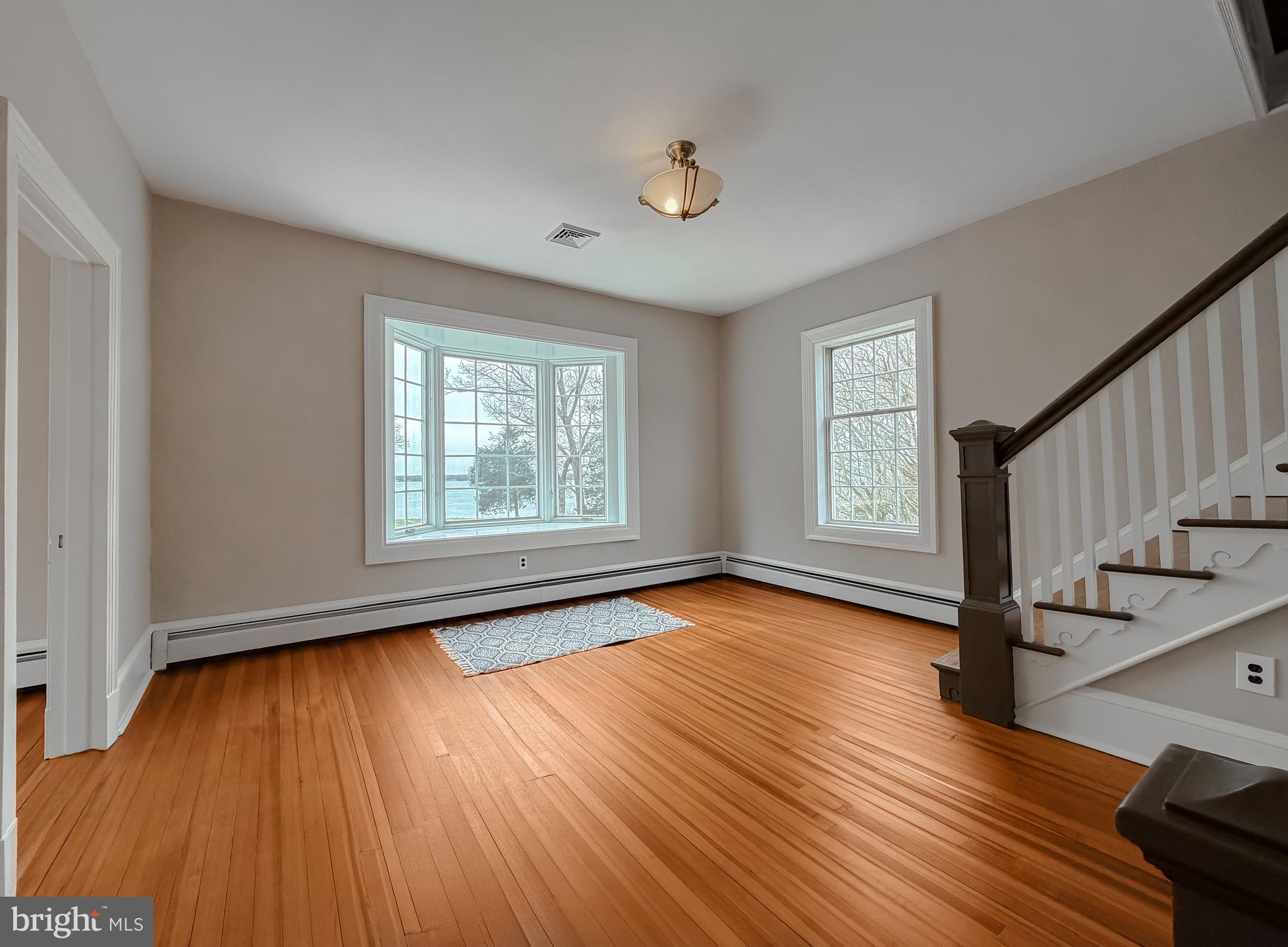 2790 Spout Lane Lusby, MD 20657 - Photo 56 of 95 a view of an empty room with wooden floor and window