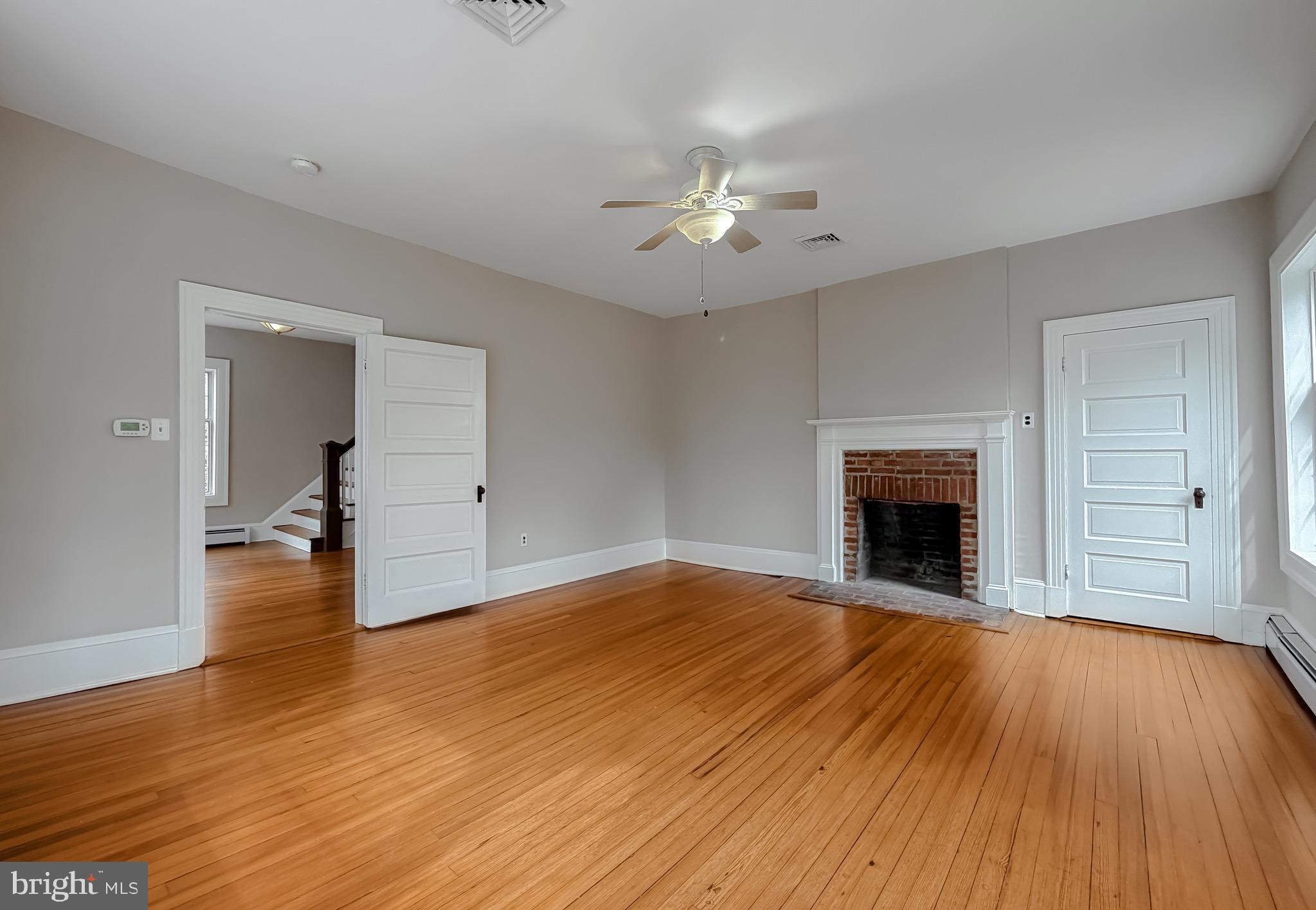 2790 Spout Lane Lusby, MD 20657 - Photo 61 of 95 a view of empty room with wooden floor and fireplace