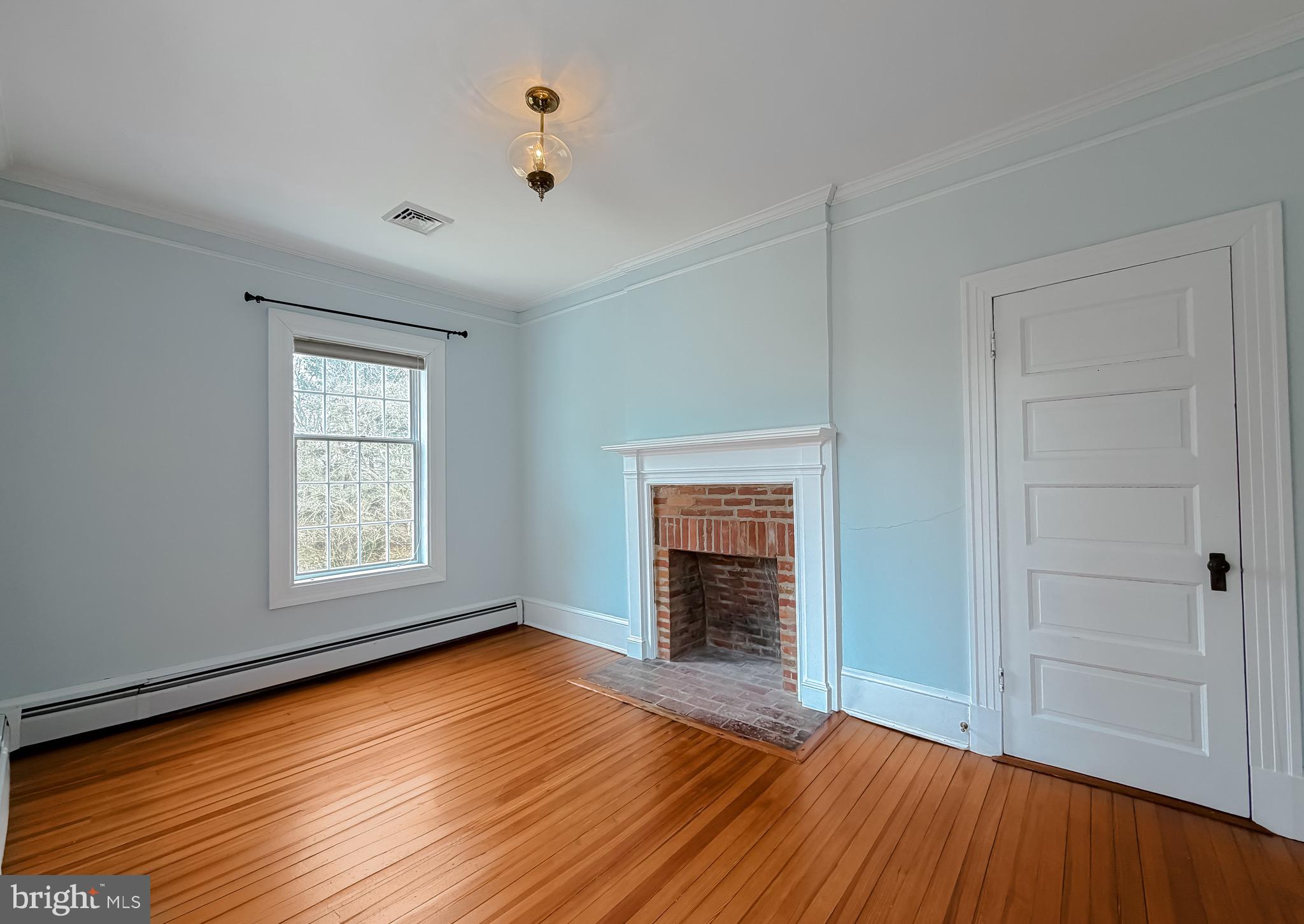 2790 Spout Lane Lusby, MD 20657 - Photo 63 of 95 an empty room with wooden floor cabinet and windows