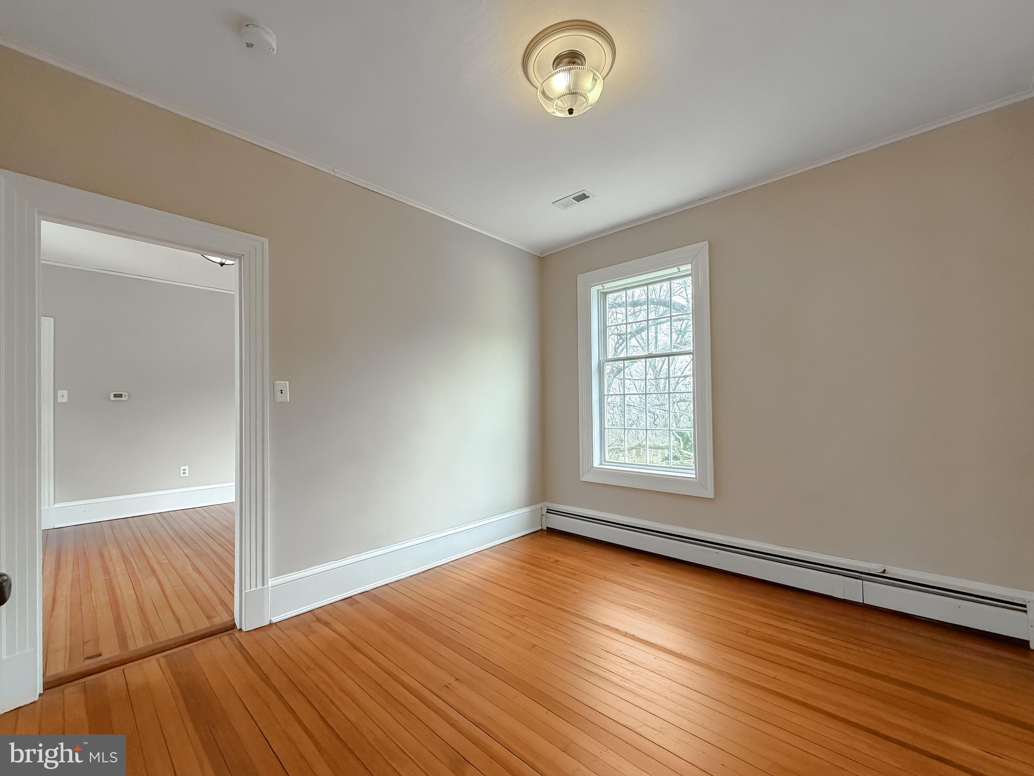 2790 Spout Lane Lusby, MD 20657 - Photo 65 of 95 an empty room with wooden floor and windows