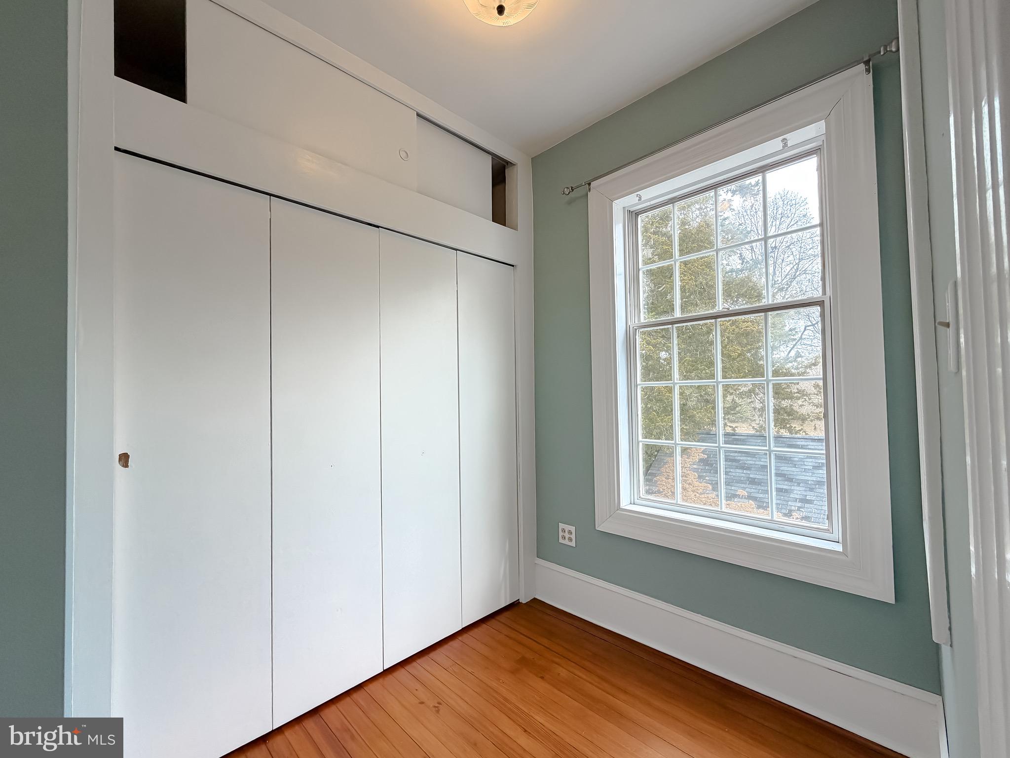 2790 Spout Lane Lusby, MD 20657 - Photo 69 of 95 a view of an empty room with wooden floor and a window