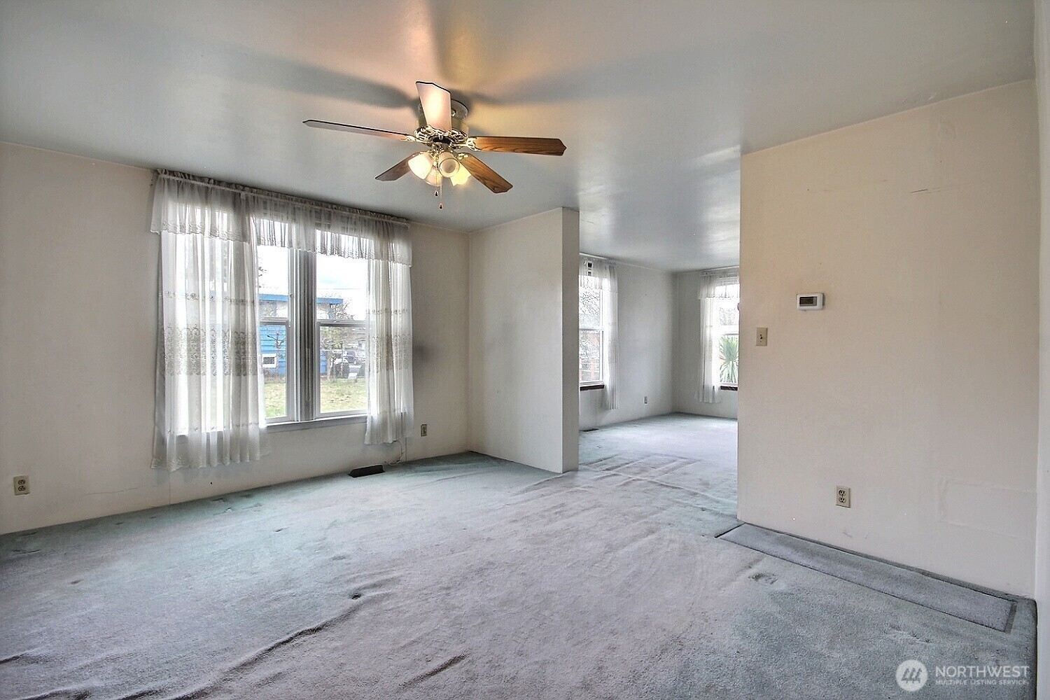 3902 South Angel Place Seattle, WA 98118 - Photo 18 of 39 a view of an empty room with chandelier fan and a window