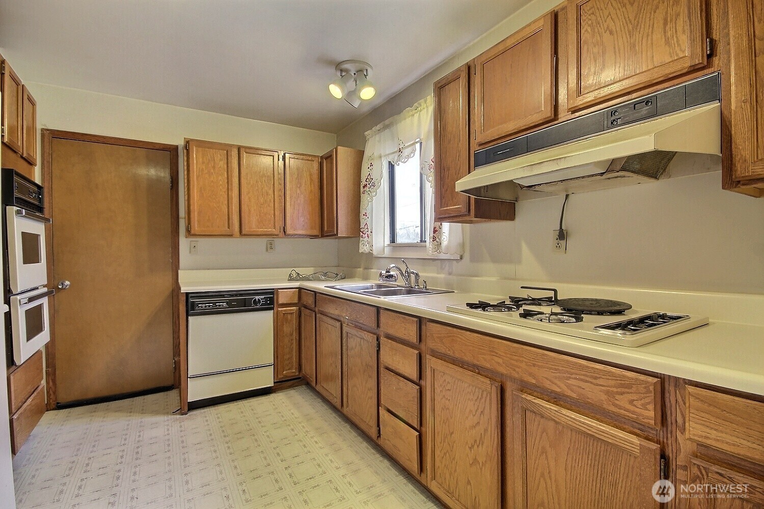 3902 South Angel Place Seattle, WA 98118 - Photo 19 of 39 a kitchen with stainless steel appliances granite countertop a sink stove and refrigerator