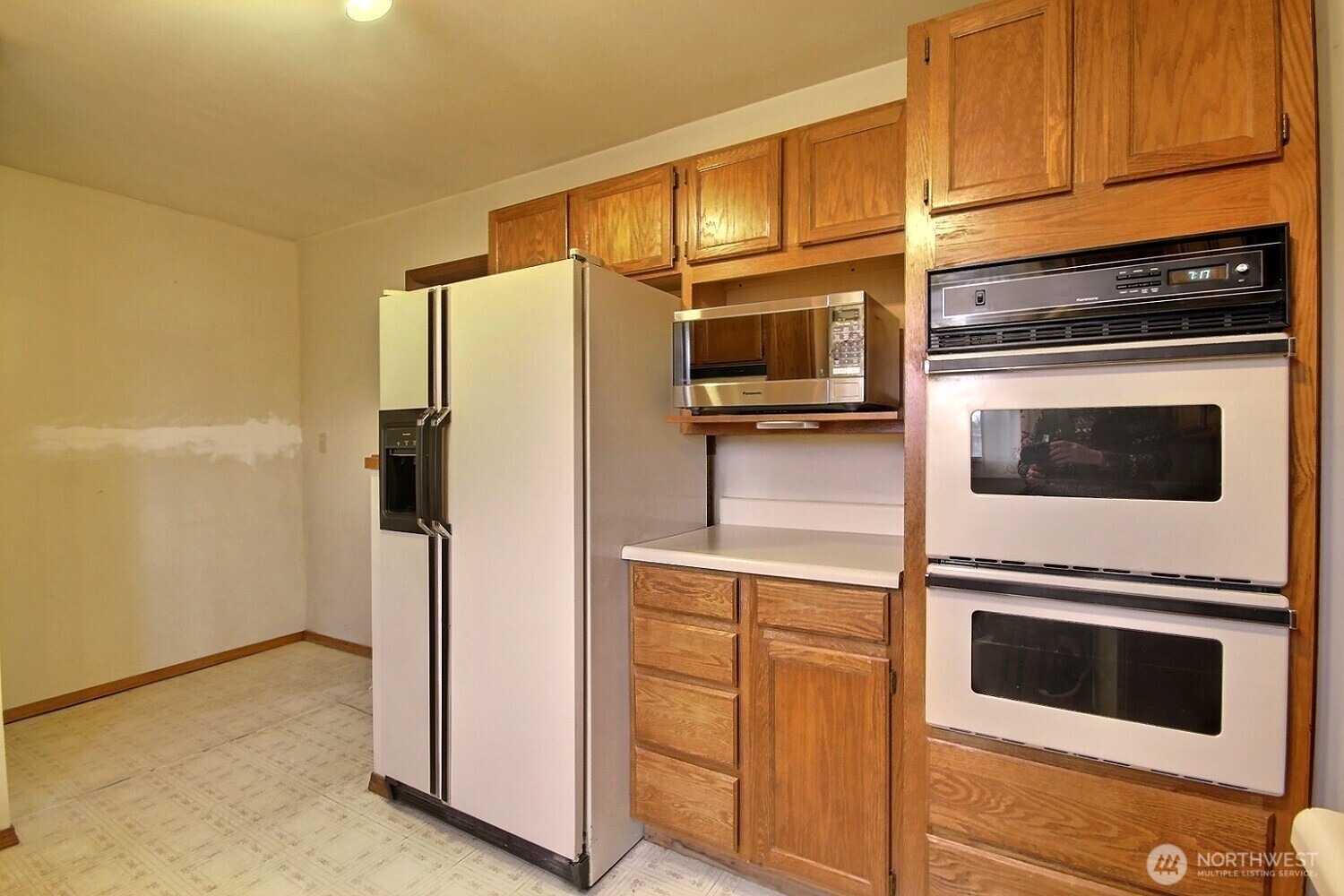 3902 South Angel Place Seattle, WA 98118 - Photo 20 of 39 a kitchen with stainless steel appliances white cabinets and a refrigerator