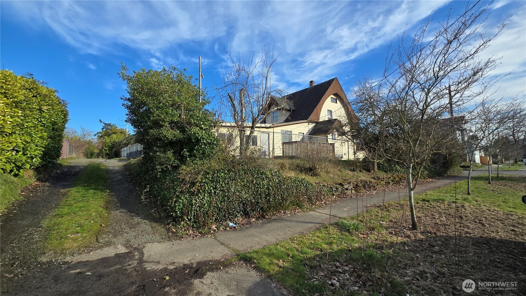 3902 South Angel Place Seattle, WA 98118 - Photo 3 of 39 a front view of a house with a yard
