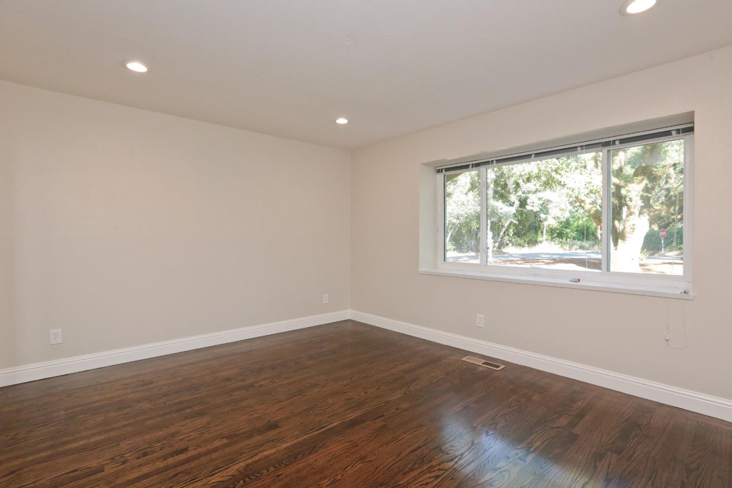 3490 Tripp Road Woodside, CA 94062 - Photo 14 of 22 a view of an empty room with wooden floor and a window