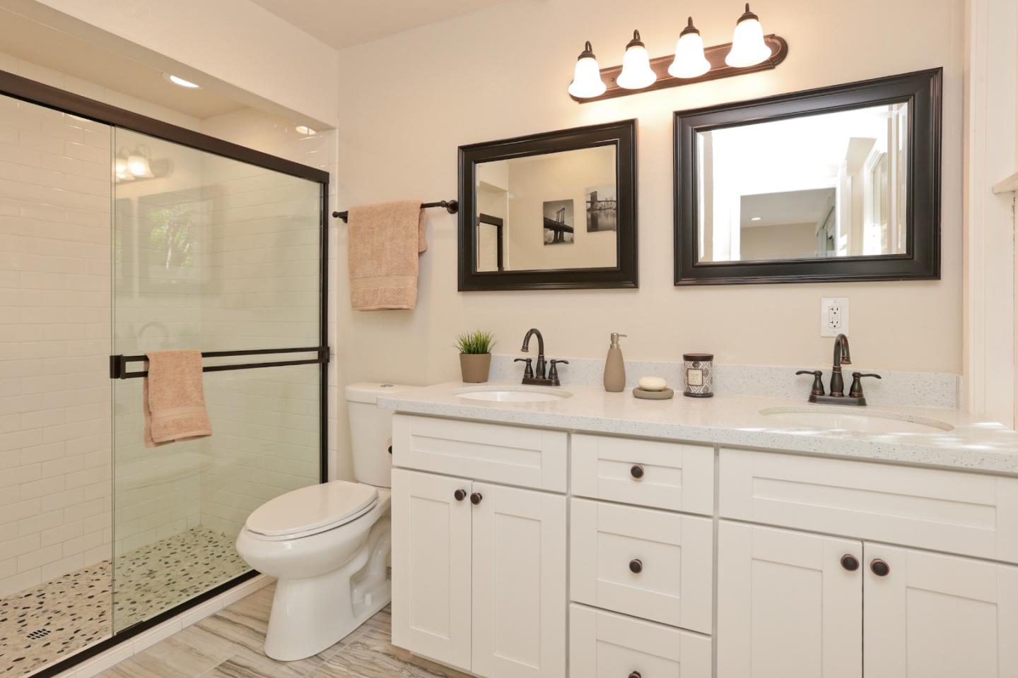 3490 Tripp Road Woodside, CA 94062 - Photo 16 of 22 a bathroom with a toilet a sink a mirror and shower