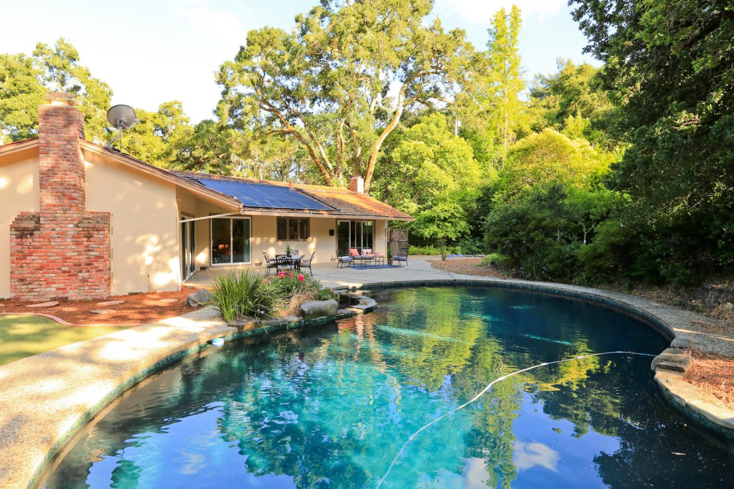3490 Tripp Road Woodside, CA 94062 - Photo 22 of 22 a view of a house with swimming pool and a yard