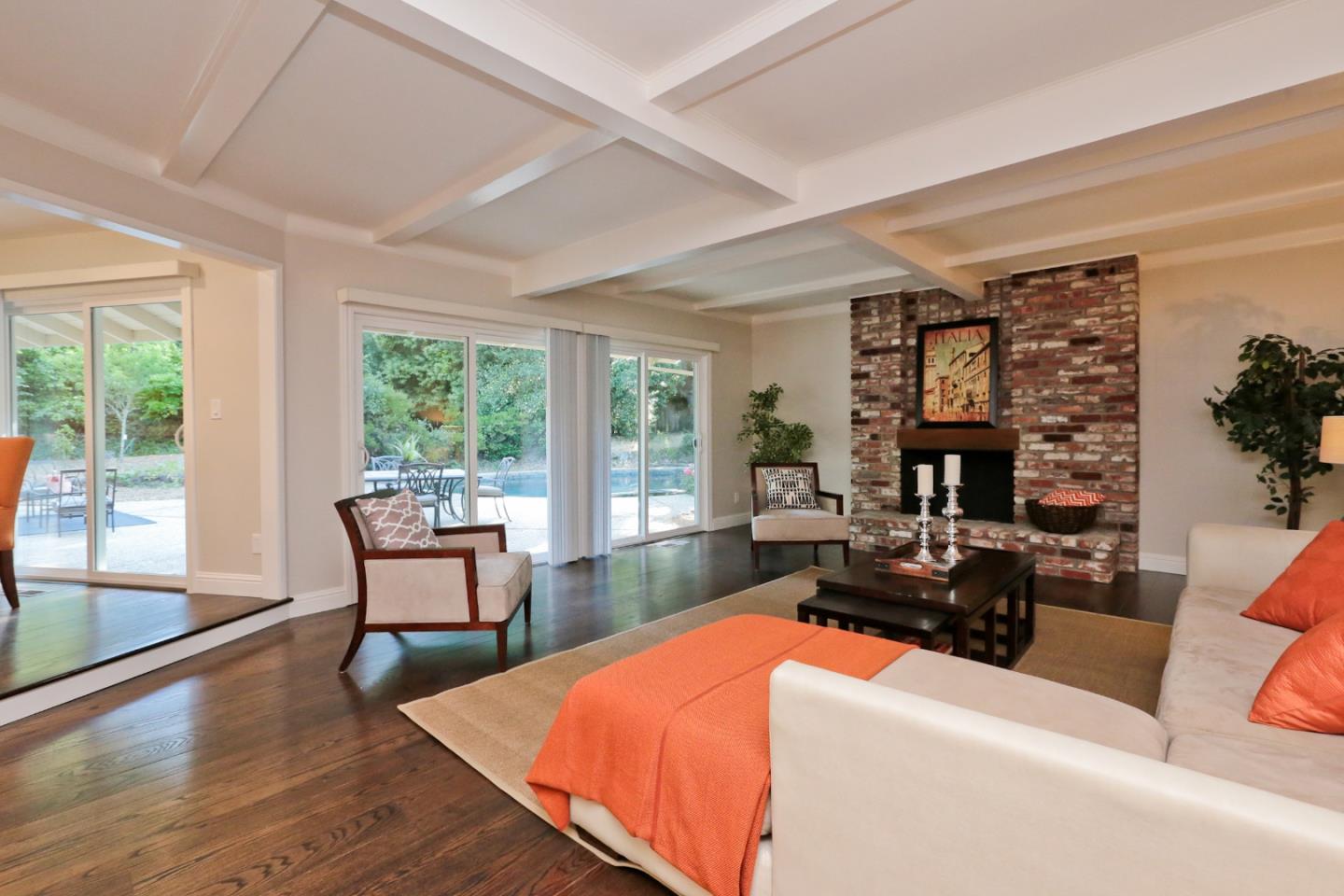3490 Tripp Road Woodside, CA 94062 - Photo 4 of 22 a living room with furniture a fireplace and large windows