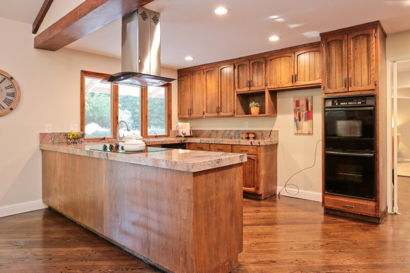 3490 Tripp Road Woodside, CA 94062 - Photo 8 of 22 a kitchen with stainless steel appliances granite countertop a stove a sink and a refrigerator