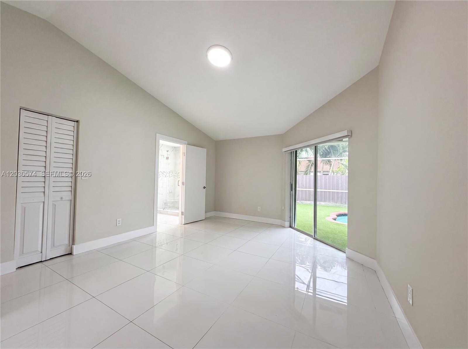 16571 Southwest 145th Avenue Miami, FL 33177 - Photo 4 of 25 a view of an empty room with a window