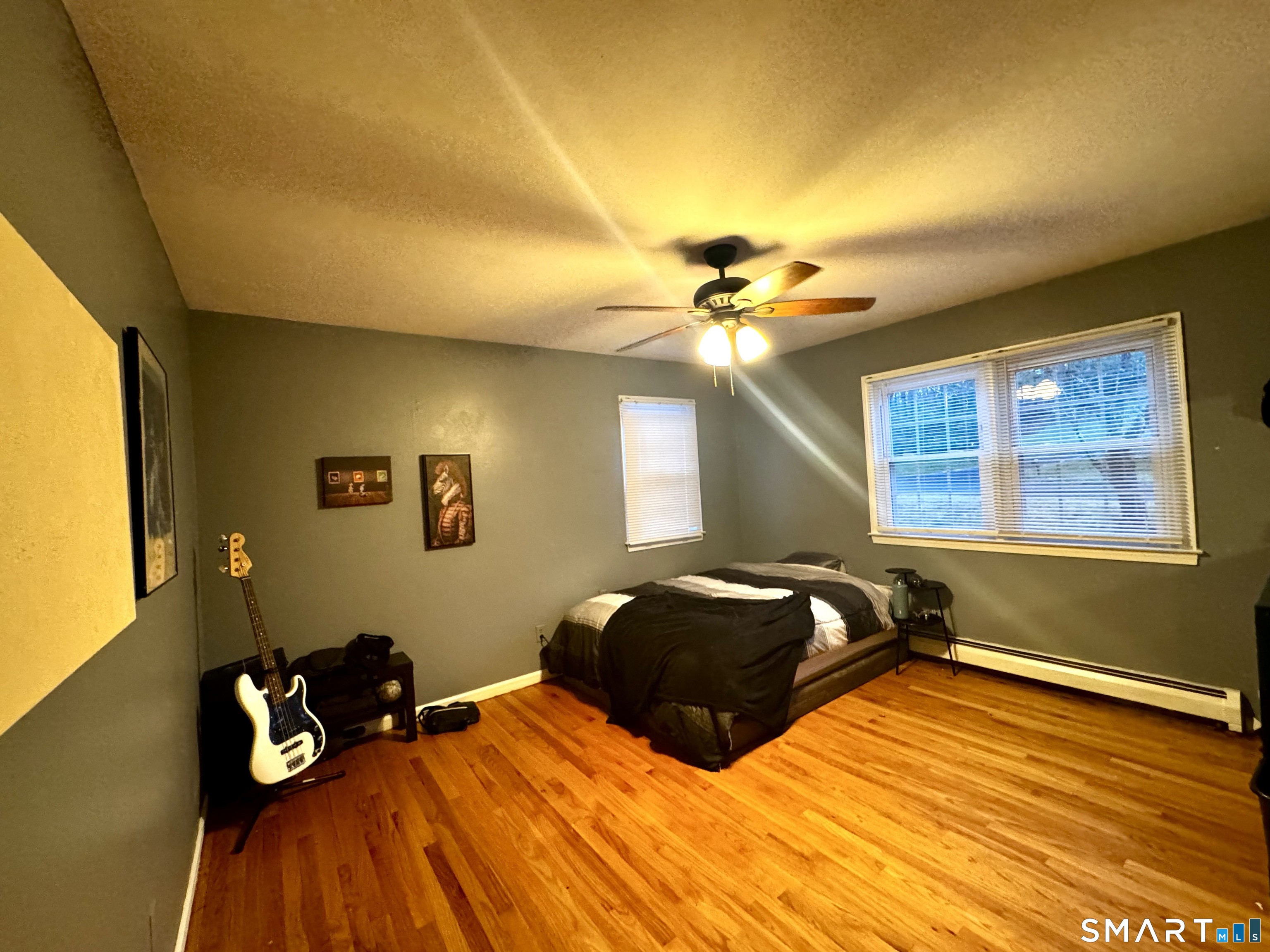 6 Redcoat Lane Trumbull, CT 06611 - Photo 16 of 30 a bedroom with a bed and wooden floor