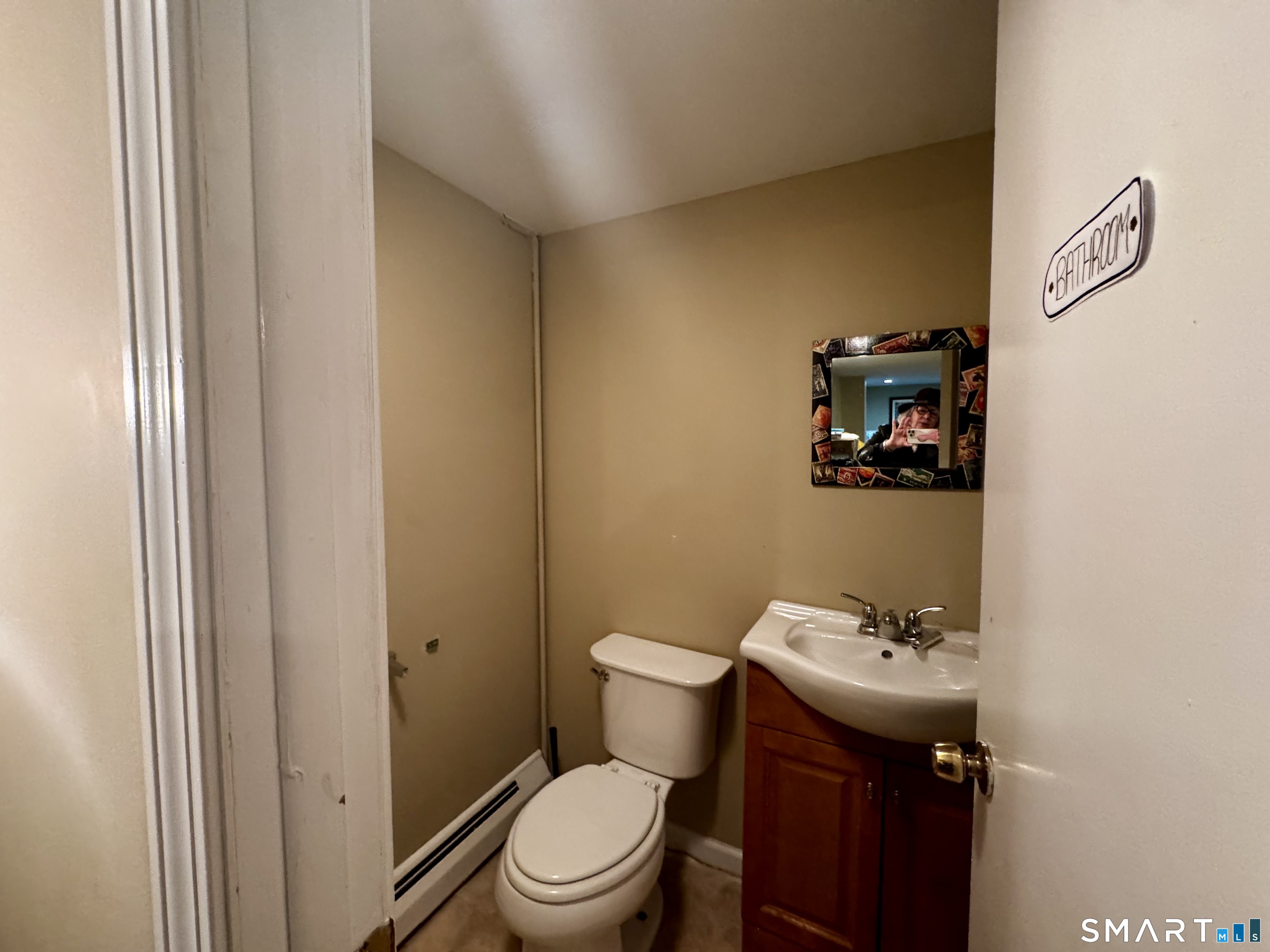 6 Redcoat Lane Trumbull, CT 06611 - Photo 18 of 30 a bathroom with a toilet sink vanity and mirror