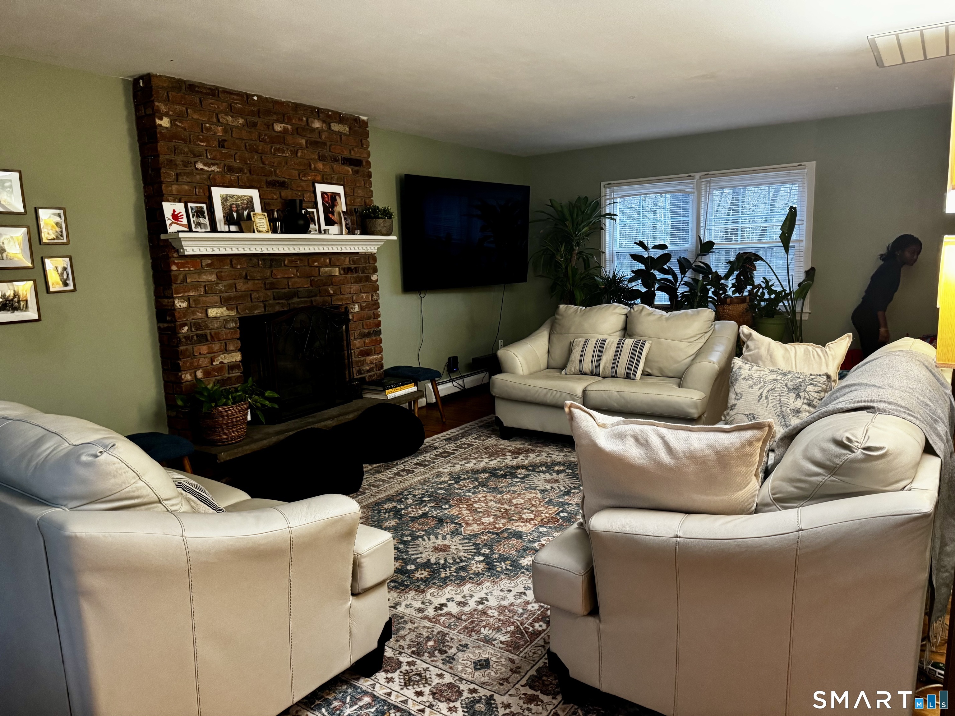 6 Redcoat Lane Trumbull, CT 06611 - Photo 7 of 30 a living room with furniture a flat screen tv and a fireplace