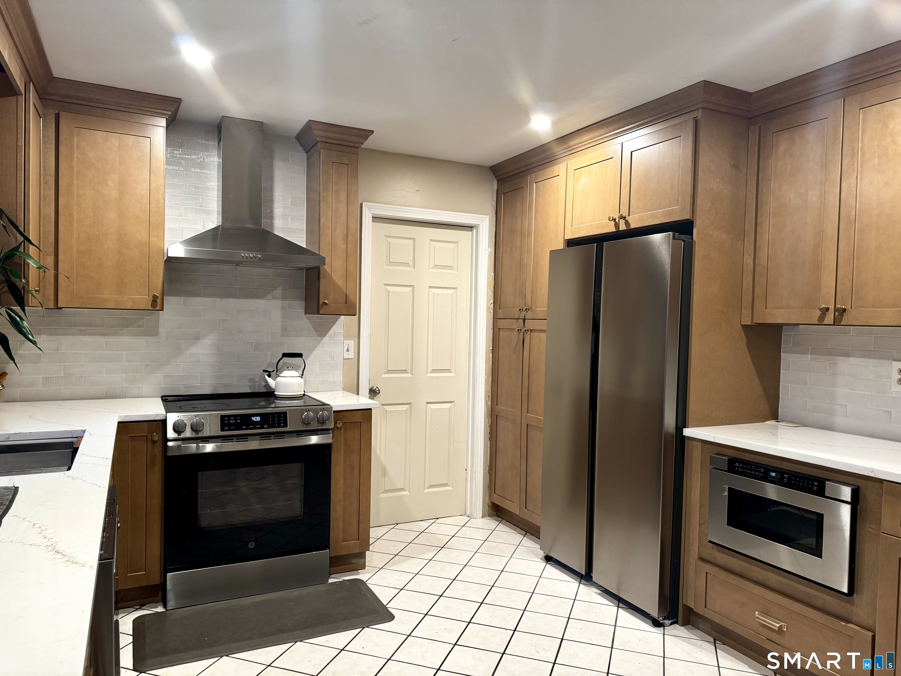 6 Redcoat Lane Trumbull, CT 06611 - Photo 10 of 30 a kitchen with stainless steel appliances granite countertop a stove a refrigerator and a microwave