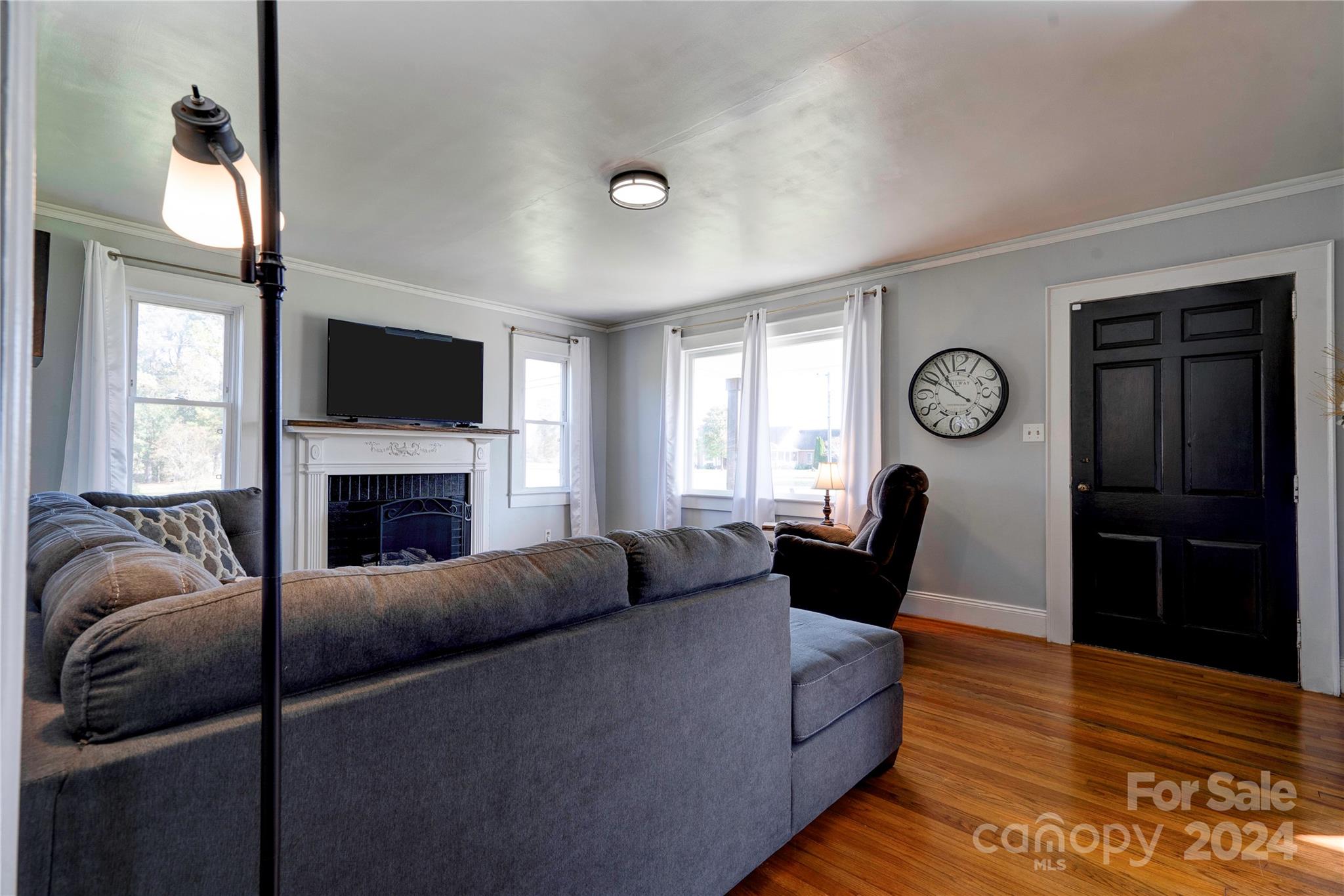 414 Poplar Springs Church Road Shelby, NC 28152 - Photo 4 of 37 a living room with furniture a fireplace a flat screen tv and a window