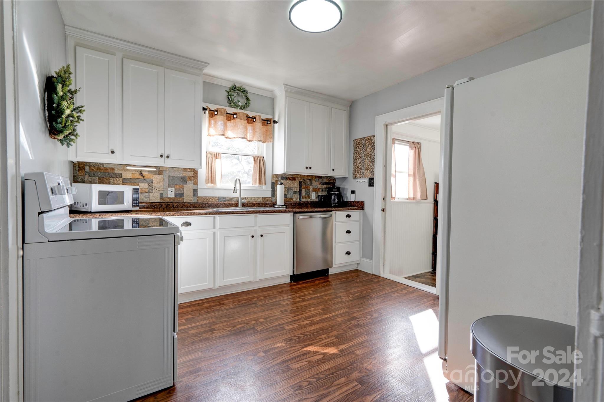 414 Poplar Springs Church Road Shelby, NC 28152 - Photo 10 of 37 a kitchen with stainless steel appliances a sink cabinets and wooden floor